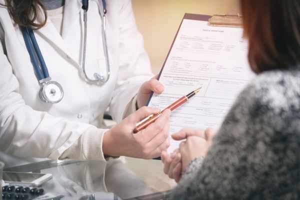 doctor helping patient